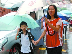 广东一学校家长义工送学生进校 引发对校门口