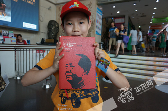 小读者展示自己淘到的《毛泽东传》。重庆市少儿图书馆供图，华龙网发