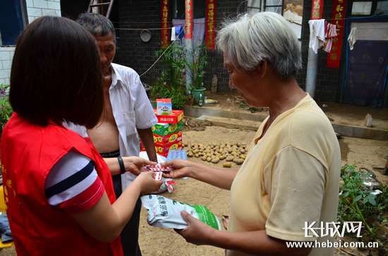 志愿者将生活物资送到受灾严重的家庭。