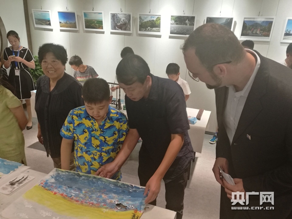 与会的中外嘉宾与北京小画家们畅谈“我心中的美丽风景”。
