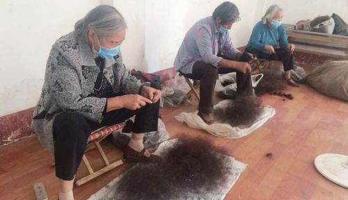 在鄄城县陈王街道西曹村的发制品就业扶贫车间，村民们正在整理头发。