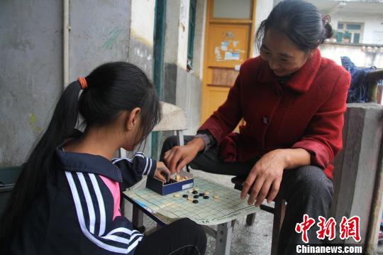 女儿从社区学会五子棋后就来教王树芬下棋，每天放学回家母女俩都要切磋几局。　吕杨　摄