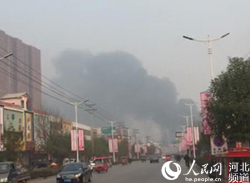 图为保定白沟新腾飞革业有限公司大火引发的浓烟飘散到数米开外。