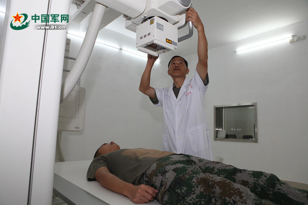 王月丽丈夫徐荣赐在为战士检查身体。