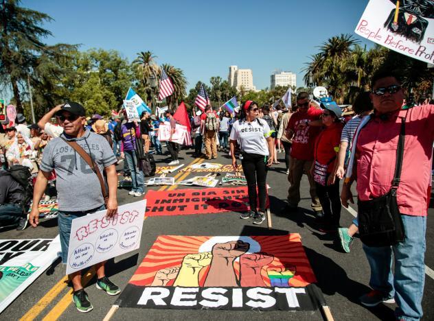People participate in a May Day protest march in Los Angeles