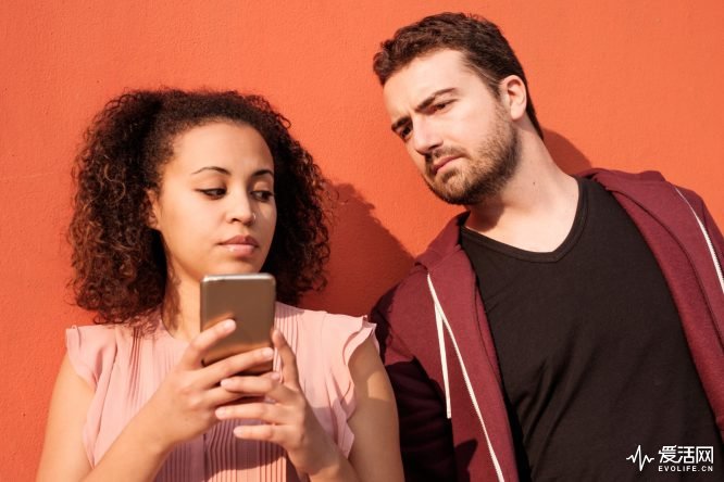 Man spying his girlfriend mobile phone