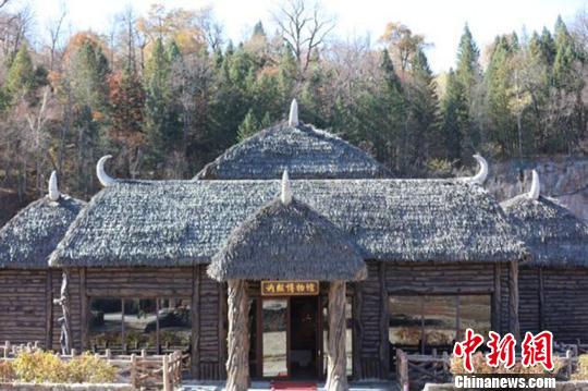 古城被周边的绿色森林环绕着，由巨石和原木搭建而成的房屋屋顶上，附着着羊骨和羊角等样式的装饰物，地域特色十足。　杨来革 摄