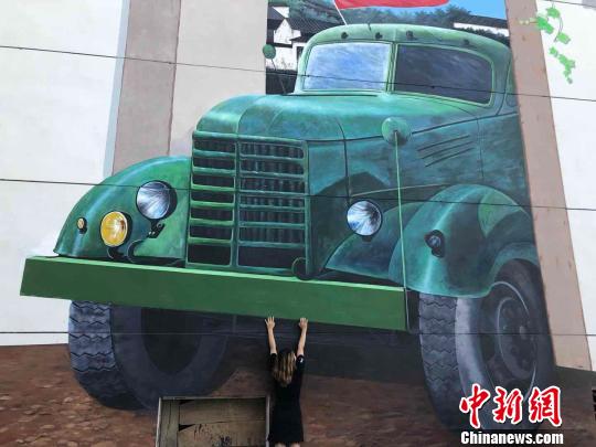 7月13日，在江西省上饶县“网红村”周石村，游客试图“爬”上大卡车。　颜子玉供图　摄