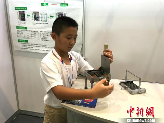 图为江苏省苏州市吴中区长桥中心小学五年级学生王国宇发明的“可调节瓜果切片器”。　钟旖 摄