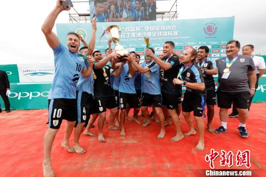 中国――拉丁美洲沙滩足球锦标赛19日在河北唐山国际旅游岛落幕。图为乌拉圭队球员与教练在欢庆夺得冠军。　徐晓跃 摄