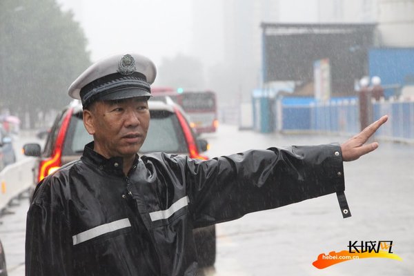 资料图:交警在雨中指挥.(图片与本文无关)